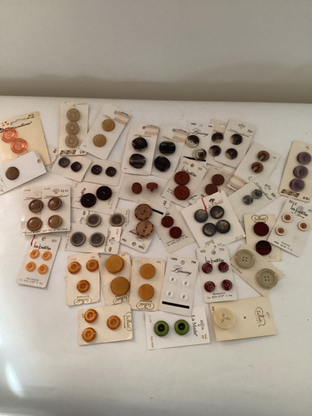 Lot of vintage buttons in yellow & brown tones. Most new on cards.
